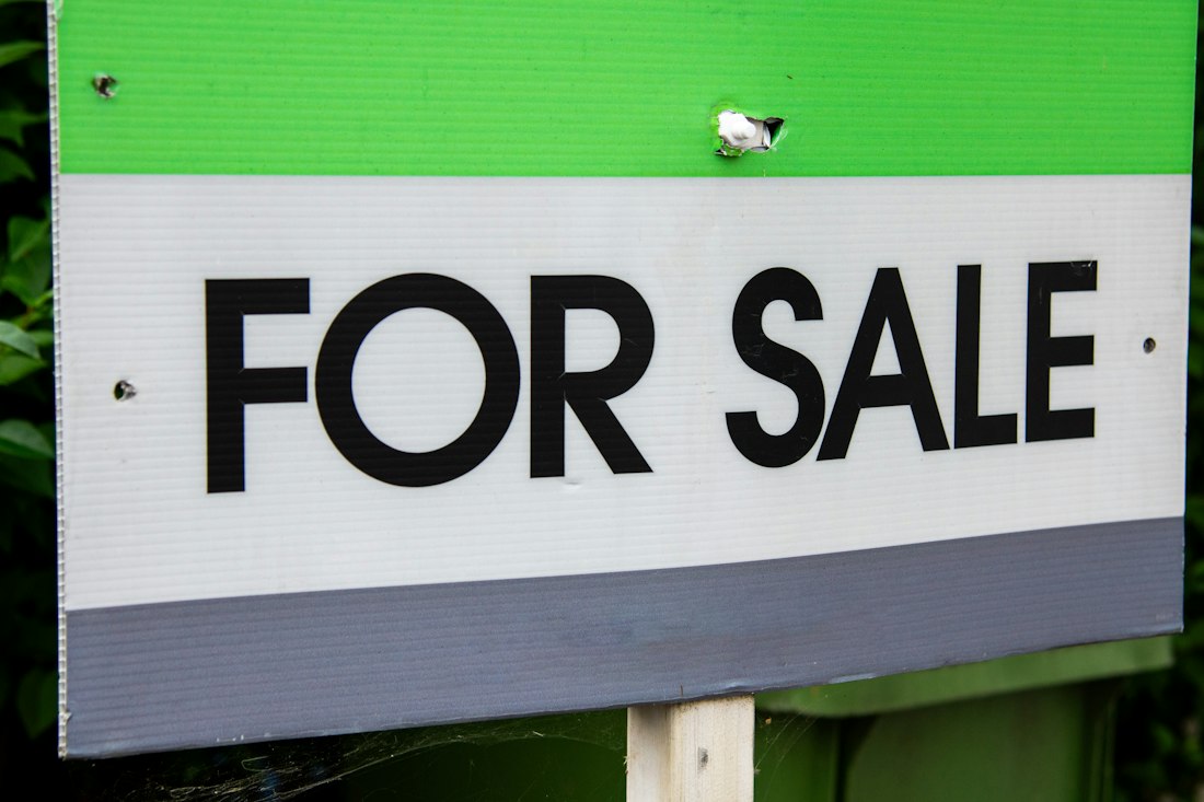 A for sale sign in front of a house